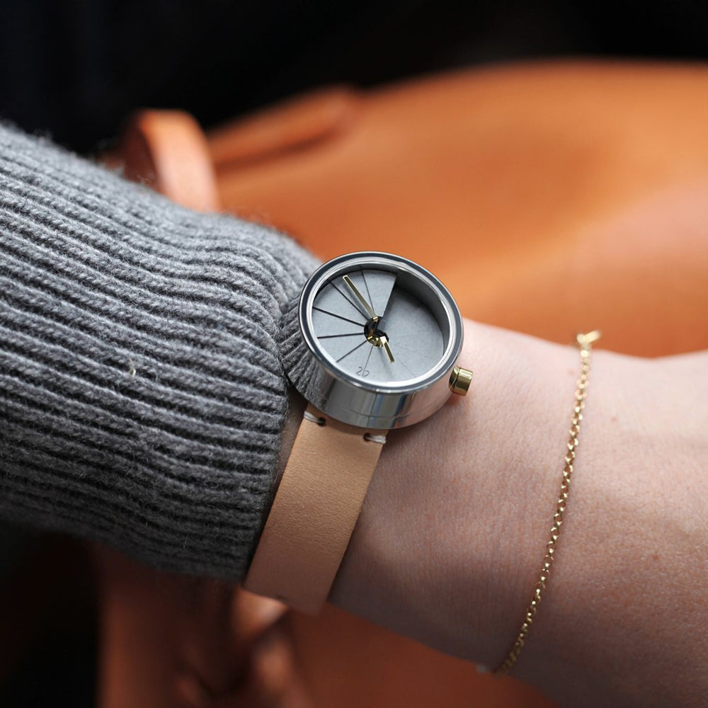 A Modern Concrete Watch With An Italian Leather Strap On A Woman's Wrist