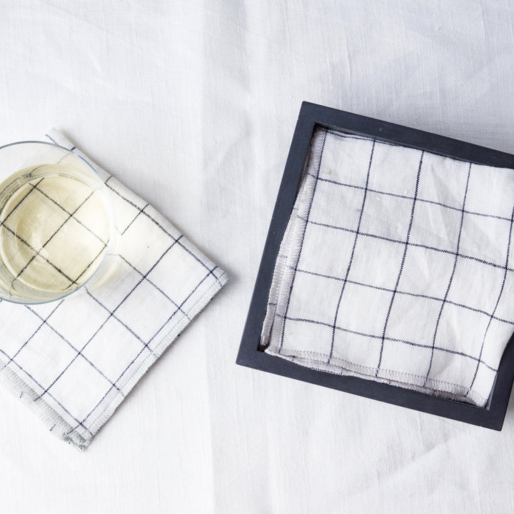 Cocktail Napkin Bin With White Napkins And A Cup Of Wine