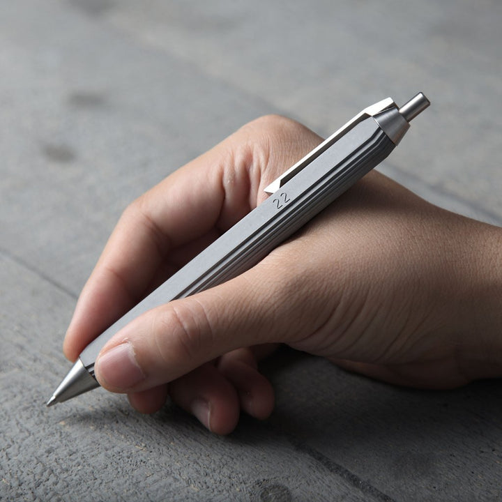 Person Holding a Modern Concrete Ballpoint Pen