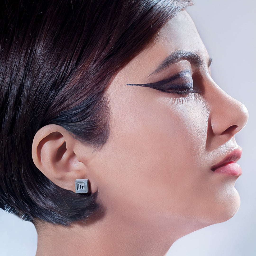 Model Wearing Cube Shaped Concrete Earrings By Material Immaterial Studio