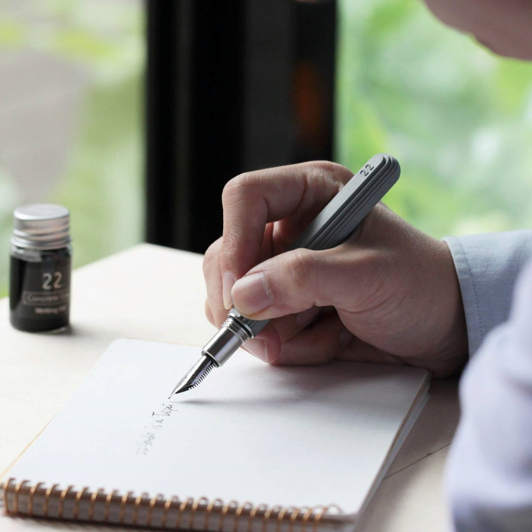 A Man Writing with a Cement Fountain Pen 