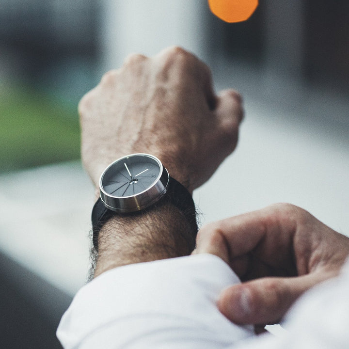 Man With A White Shirt Wearing A Modern Concrete Watch With A Black Italian Leather Strap