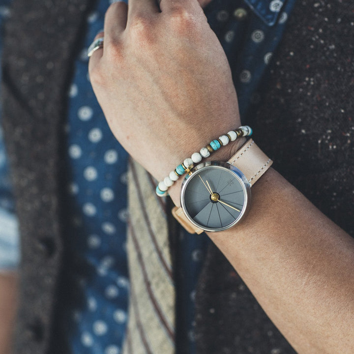 Person's Wrist Wearing A Bracelet And A Concrete Watch By 22STUDIO