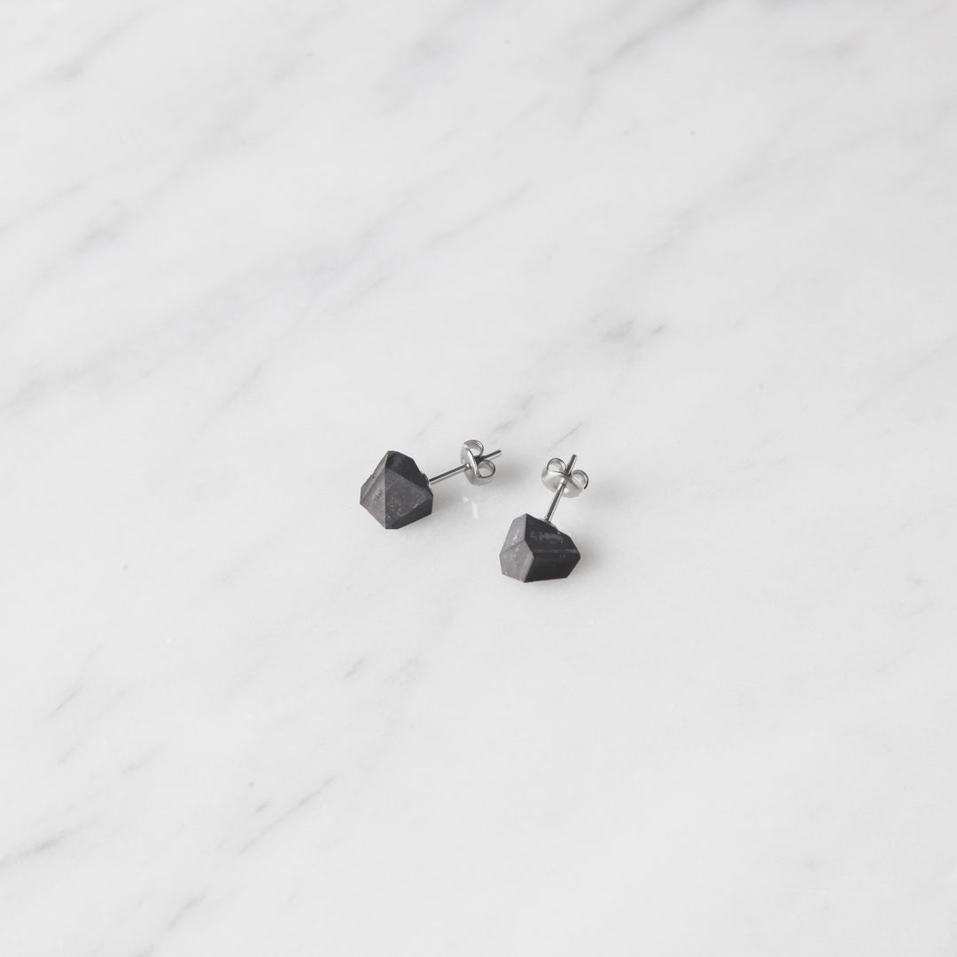 22STUDIO Concrete Rock Earrings Dark Gray On A Marble Counter